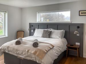 a bedroom with a large bed with a window at Croft 105 in Melvich