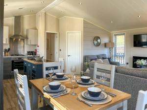 a dining room and living room with a table and chairs at The Valerie Jean in Bridlington