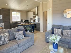 a living room with two couches and a kitchen at The Valerie Jean in Bridlington