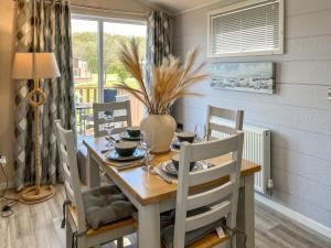 a dining room with a table and chairs and a window at The Valerie Jean in Bridlington