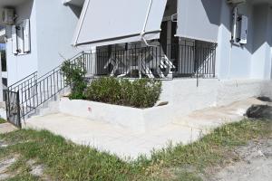 a building with a balcony with plants on it at Avra Port House in Porto Heli
