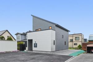 a house with a grey and white garage at Hoshiyado Higashikawa in Higashikawa
