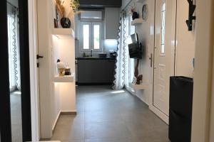 a hallway of a home with a kitchen and a door at Avra Port House in Porto Heli +12 photos