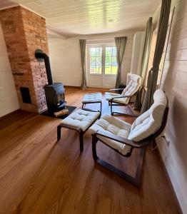 a living room with couches and a wood stove at Lake Lodge Labanoras in Šnioriškės