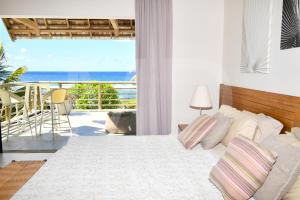 a bedroom with a bed and a view of the ocean at Peter's Beach House in Poste Lafayette +38 photos