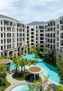 an aerial view of a resort with two pools and palm trees at Legendary 2 Bdr Comfort in Bang Tao Beach