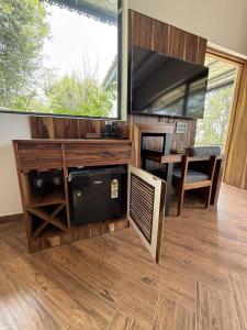 a living room with a large tv and a table at Mum Griham in Rewalsar