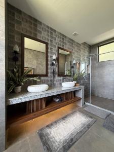 a bathroom with two sinks and two mirrors at Mum Griham in Rewalsar +55 photos