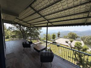 a balcony with chairs and a view of the mountains at Mum Griham in Rewalsar