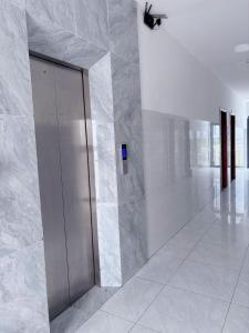 a hallway with a silver elevator in a building at Khách sạn Hotel 6 in Ấp Tân Thành