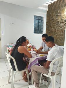 a group of people sitting around a table at Pousada Bom Jesuss in Juazeiro do Norte