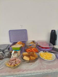 a table with several plates of food on it at Pousada Bom Jesuss in Juazeiro do Norte