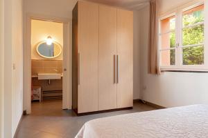 a bedroom with a large wooden cabinet and a sink at Appartamento Il Nespolo in Pontedera