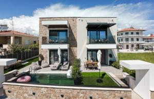 an image of a house with a swimming pool at Trithiron Luxury Villas in Nea Moudania