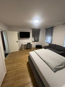 a bedroom with a bed and a flat screen tv at Ethical Choice Residence in Kaiserslautern