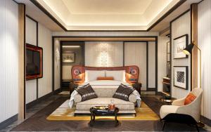 a bedroom with a bed and a couch and a table at Avani Plus Lanexang Vientiane Hotel in Vientiane
