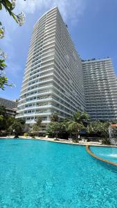 a large building with a large pool in front of it at View Talay Condominium by Vlad Property in Pattaya South