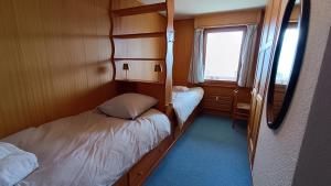 a small room with two beds and a mirror at Majestic 424 in Bagnes