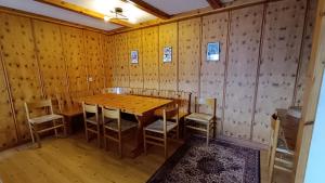 a dining room with a wooden table and chairs at Majestic 424 in Bagnes