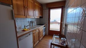 a kitchen with wooden cabinets and a sink and a window at Majestic 424 in Bagnes +2 photos