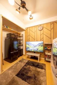 a living room with a large flat screen tv at New コスパ重視セール開催中!久留米駅徒歩5分コンビニ1分!ファミリー 友人快適!キッズエリア大好評 in Kurume