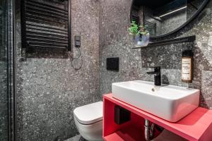 a bathroom with a sink and a toilet at Savoy Hotel in Frankfurt