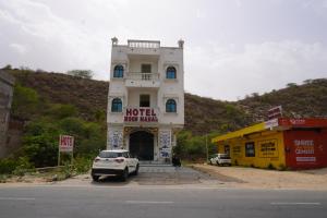 a white car parked in front of a building at Hotel Moon Mahal in Jaipur