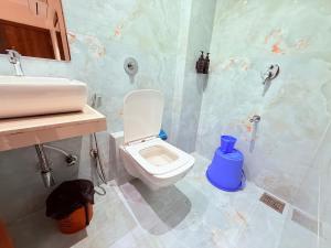 a bathroom with a toilet and a sink at Hotel Adkar Residency Borivali West in Mumbai +14 photos
