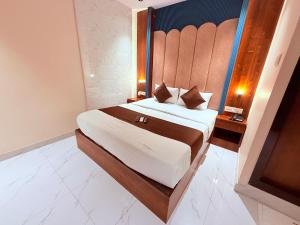a bedroom with a large bed with a headboard at Hotel Adkar Residency Borivali West in Mumbai