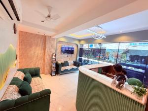 a child sitting in a tub in a living room at Hotel Adkar Residency Borivali West in Mumbai