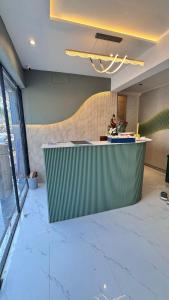 a lobby with a green counter in a room at Hotel Adkar Residency Borivali West in Mumbai