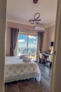 a bedroom with a bed and a view of the ocean at Athena Charming Rooms in Taormina