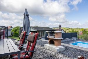 a backyard with a pool and an outdoor playground at Ferienhaus Eisfelder Blick in Eisfeld
