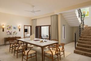 a dining room with a table and chairs at Oasis County Villas in Bangalore