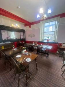 a dining room with tables and chairs in a restaurant at Windermere Bed and Breakfast in Windermere