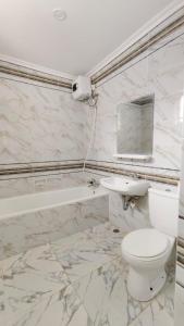 a bathroom with a toilet and a sink at Villa Dalia Puncak N5-10 in Cikundul +16 photos