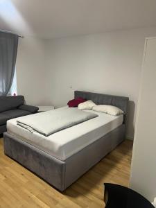 a bedroom with a bed and a couch at Ethical Choice Residence in Kaiserslautern +28 photos
