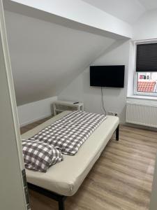 a bedroom with a bed and a flat screen tv at Ethical Choice Residence in Kaiserslautern