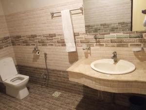 a bathroom with a sink and a toilet at Fivee Hotel Model Town Multan in Multan
