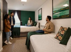 a group of people standing in a hotel room at Sidemersey Livings- Rare Accessible 2BR Liverpool City Centre Apartment in Liverpool