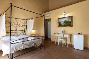 a bedroom with a bed and a table and a desk at La Locanda degli Amici in Santa Teresa di Riva +38 photos
