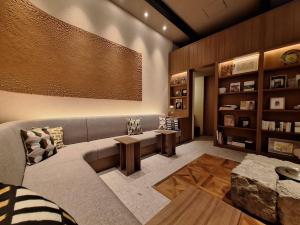 a living room with a couch and a table at Hotel MODA in Yufu