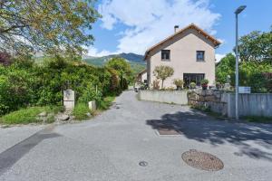 a house on a street with a driveway at Location Vacances Chorges in Chorges