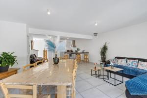 a living room with a table and a couch at Location Vacances Chorges in Chorges