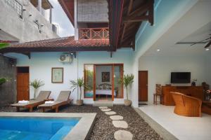 a living room with a swimming pool in a house at Hildiman Villa Kuta - Two Bedroom Private pool in Kuta