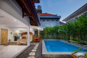 a swimming pool in the backyard of a house at Hildiman Villa Kuta - Two Bedroom Private pool in Kuta