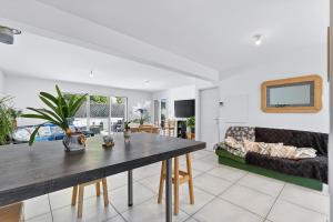 a living room with a table and a couch at Location Vacances Chorges in Chorges