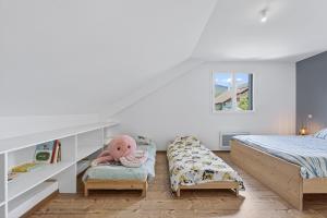 a bedroom with a bed and a stuffed elephant on a bench at Location Vacances Chorges in Chorges