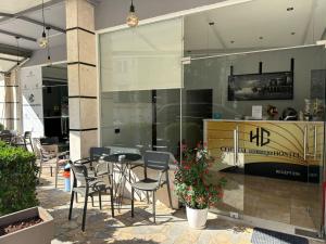 a restaurant with tables and chairs in a building at Central Boutique Hostel in Sarandë