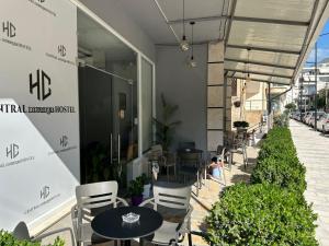 a restaurant with tables and chairs in front of a building at Central Boutique Hostel in Sarandë +36 photos